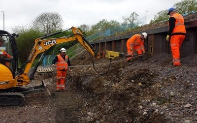 Westbury Station 014-enhanced Plati-drain being driven through sheet piling by an excavator
