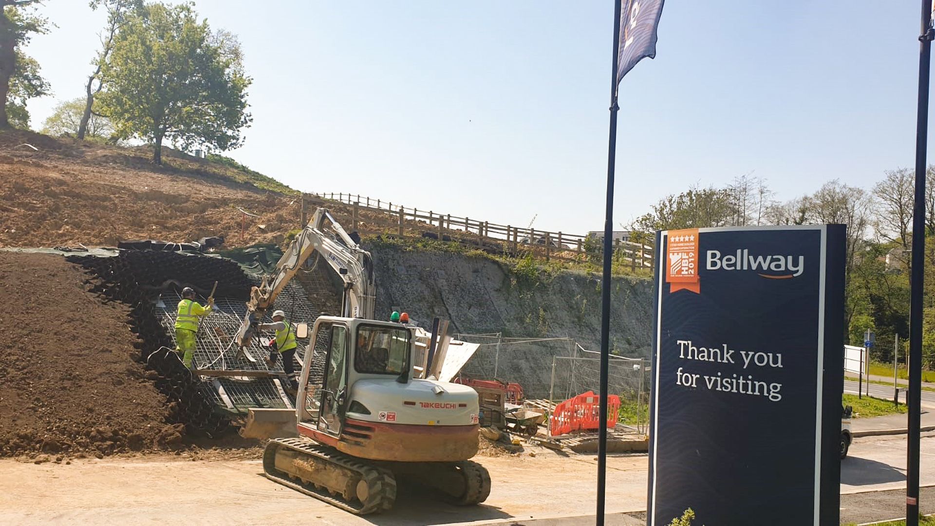 001 - ehnanced Small excavator driving earth anchors on a slope