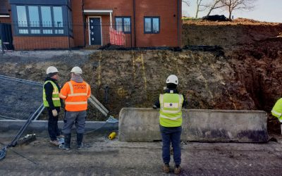 Clean it Workers looking at failed slope