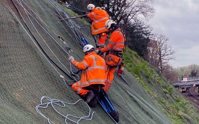 Farnborugh Cutting - Phase ii - 34 Workers abseiling down a slope to install earth anchors through erosion control matting