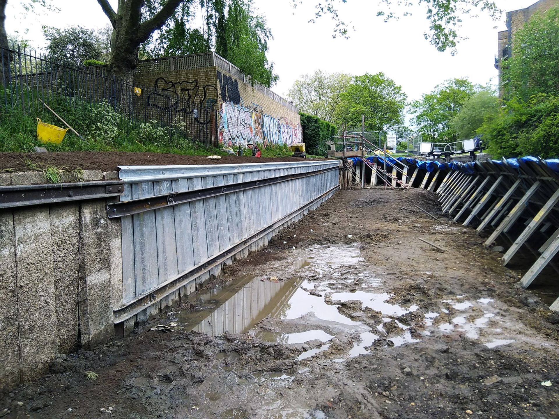 Anchored sheet piling alongside canal