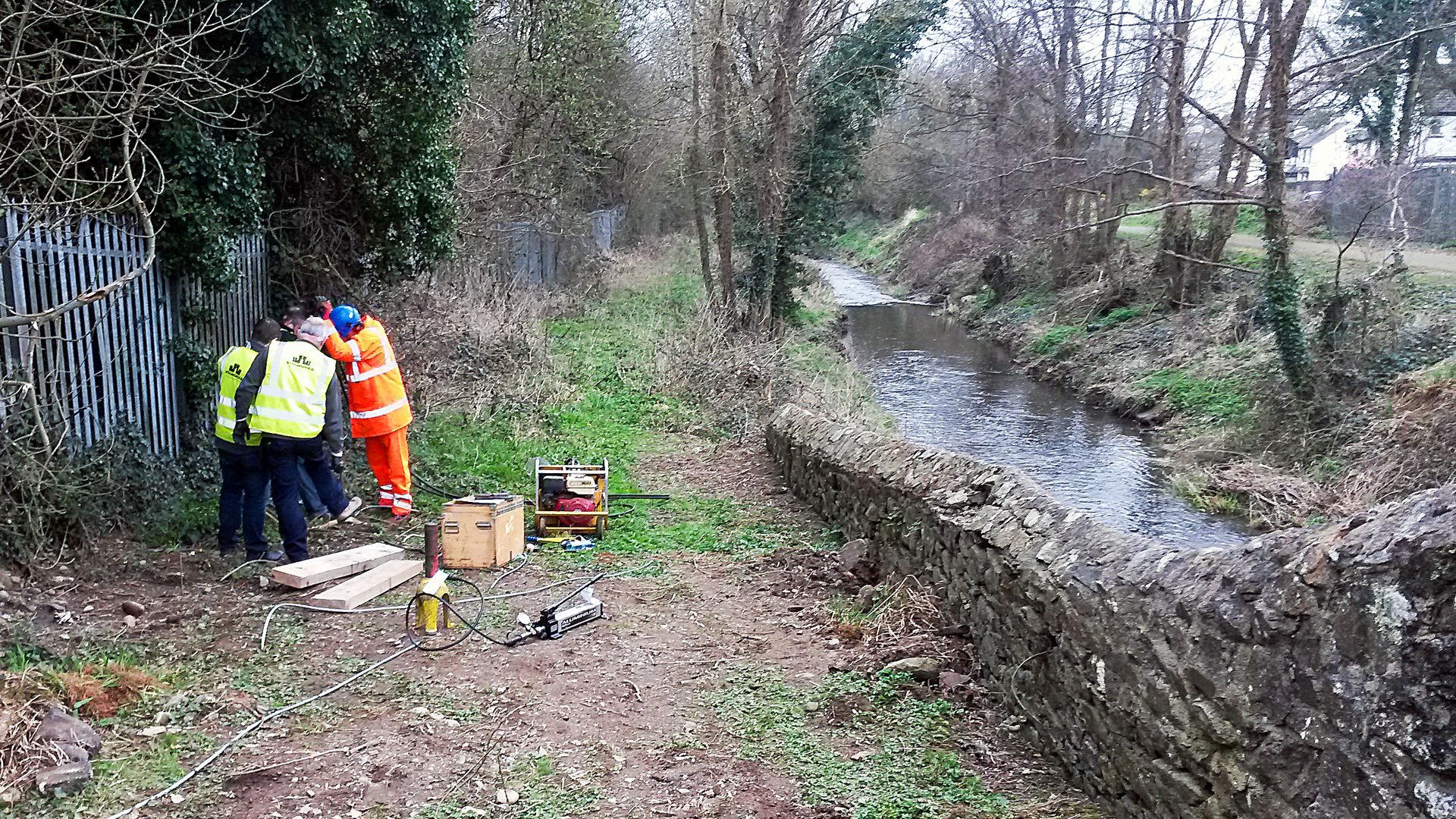 20180411_140005 Team of people installing earth anchors alongside a canal