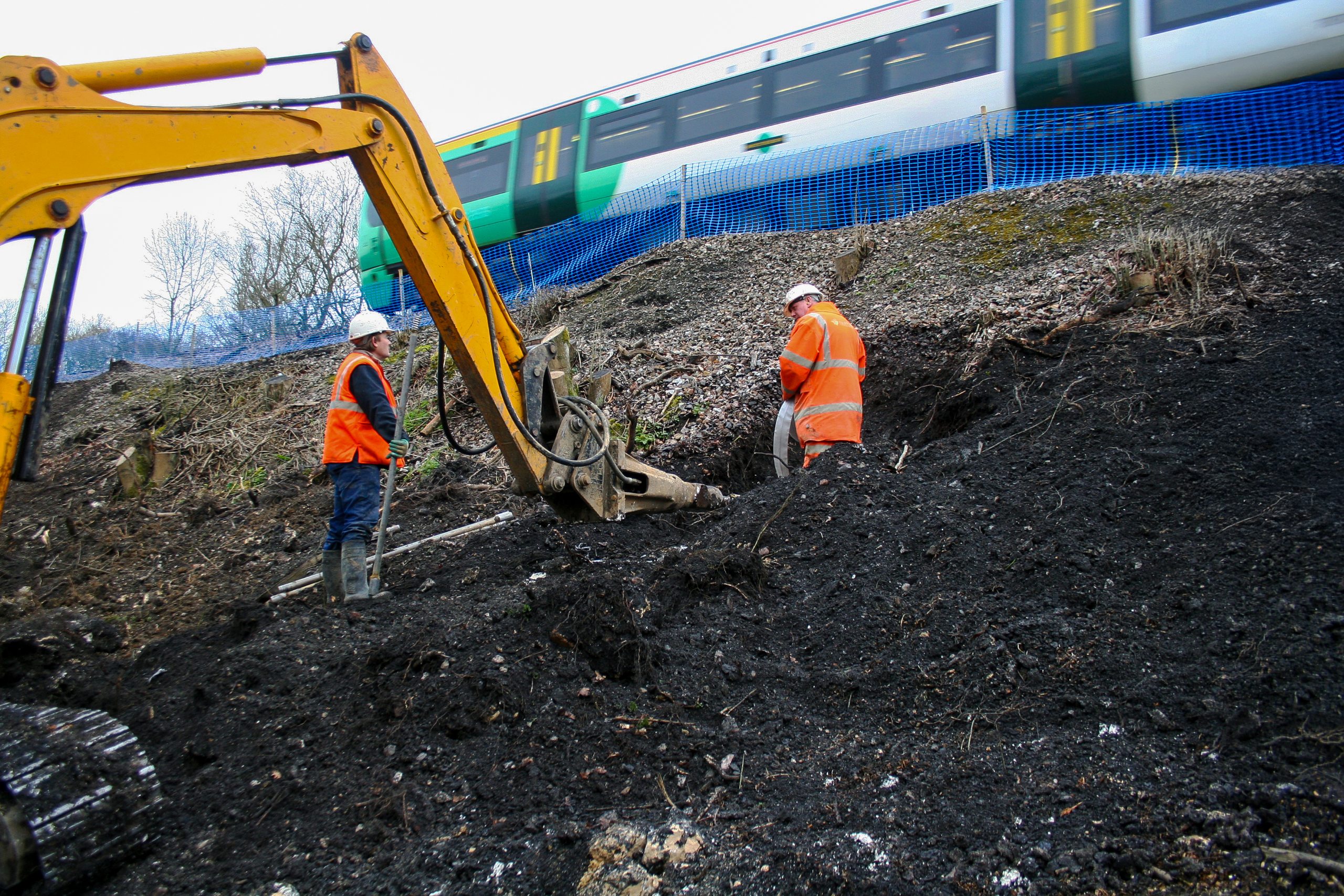 Burgess Hill Embankment Strengthening 068 - Enhanced Plati-Drain being installed to alleviate pore water pressure from railway embankment